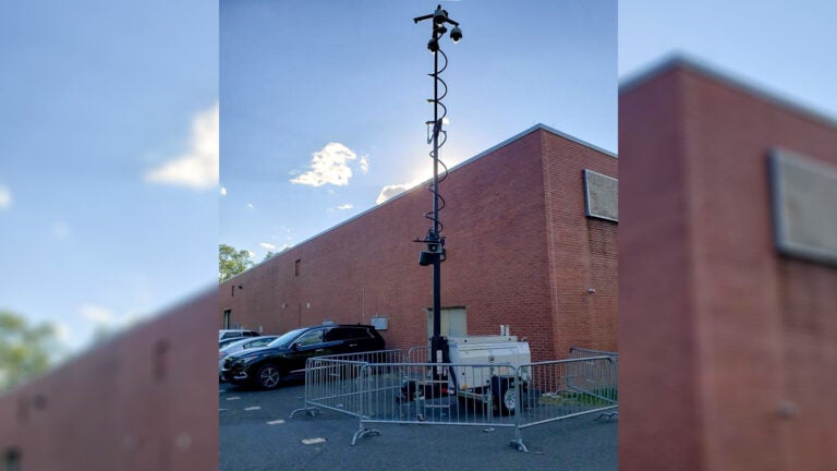 A surveillance camera is visible outside of a building.