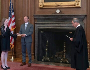 Chief Justice John G. Roberts, Jr., administers the judicial oath to Judge Amy Coney Barrett at the Supreme Court