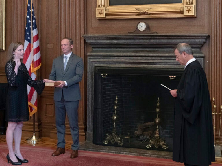 Chief Justice John G. Roberts, Jr., administers the judicial oath to Judge Amy Coney Barrett at the Supreme Court