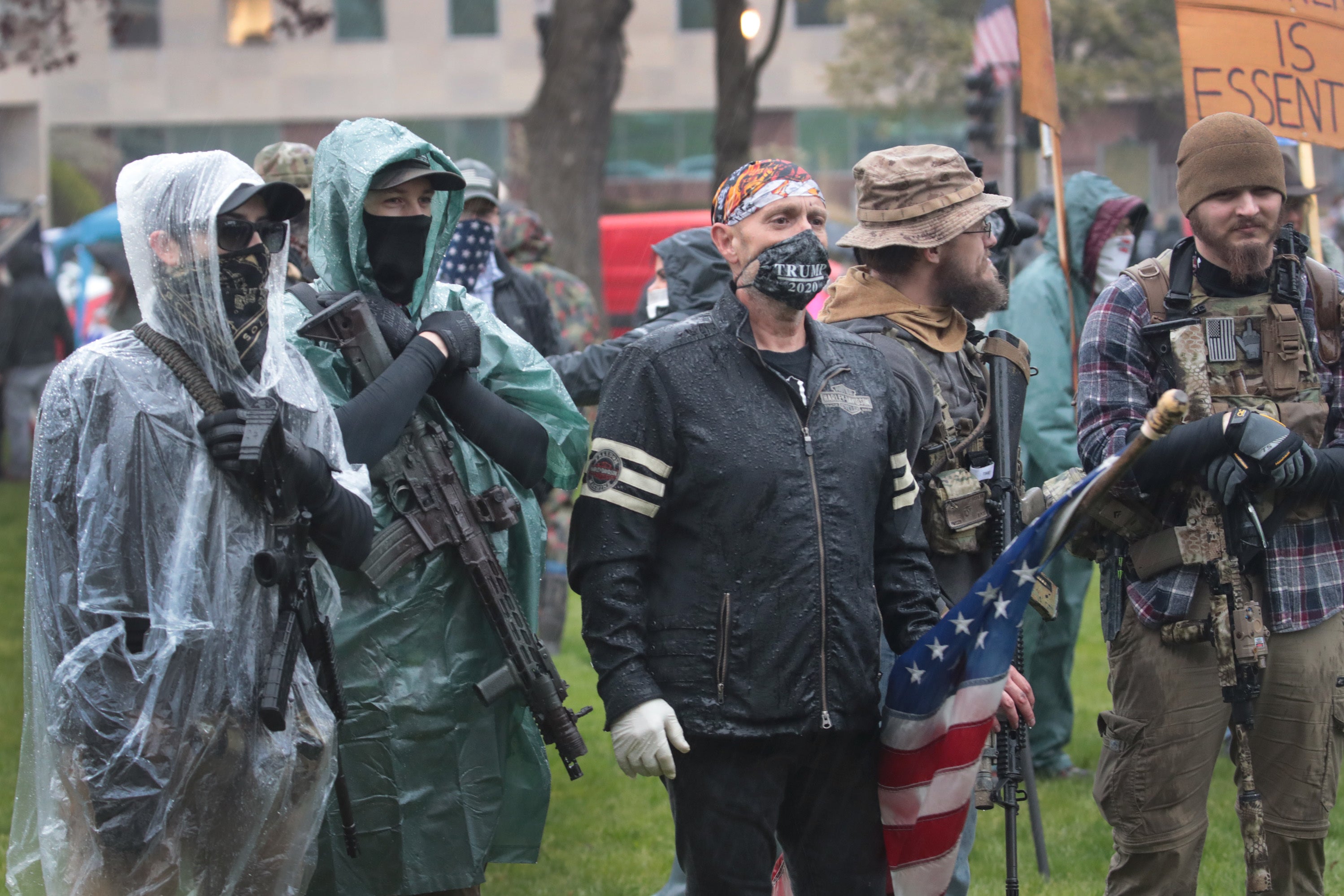 Demonstrators carrying guns hold a rally in front of the Michigan Capitol to protest the governor's stay-at-home order on May 14 in Lansing, Mich. Gov. Gretchen Whitmer imposed the order to curtail the spread of COVID-19.