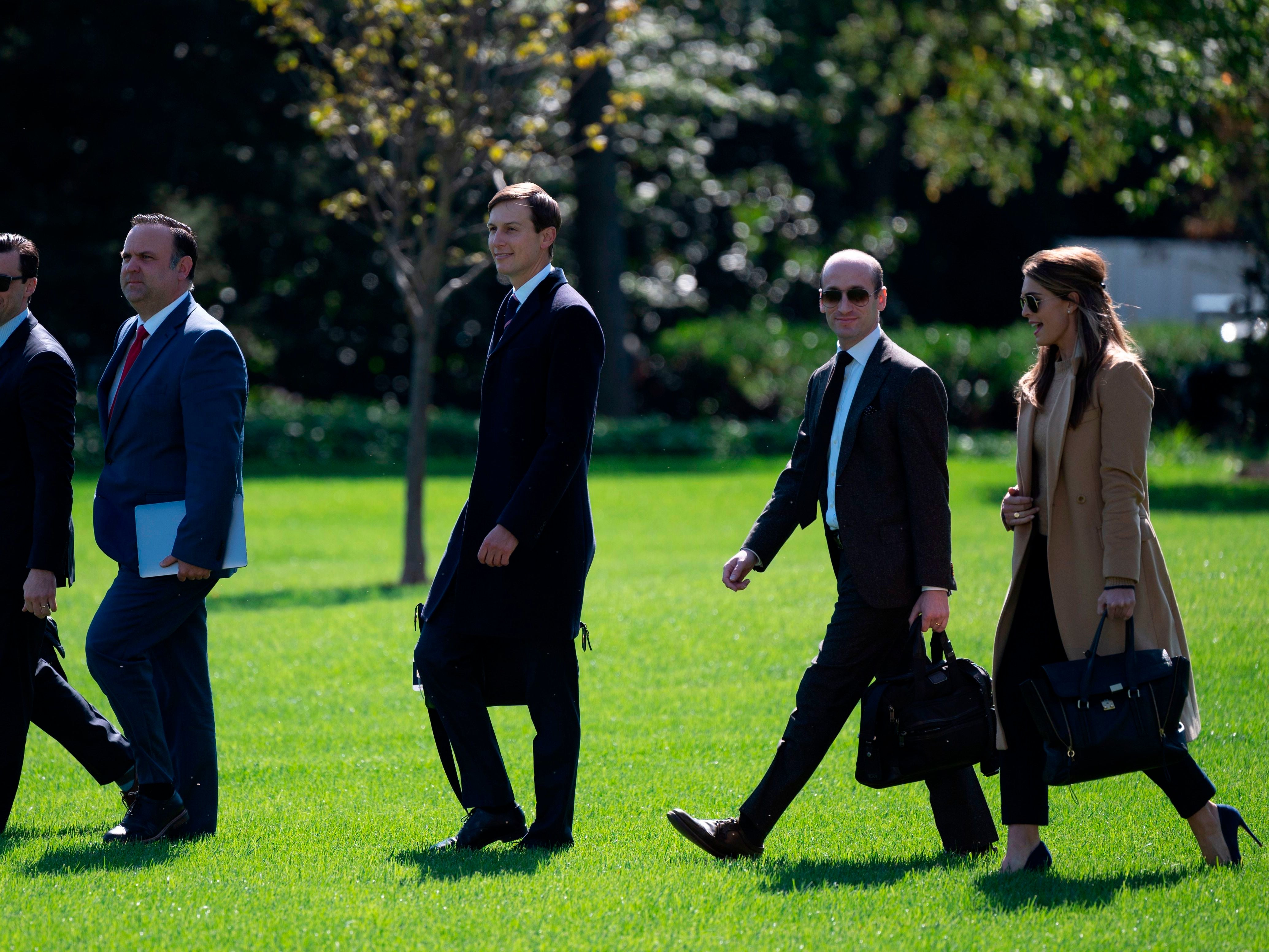 Hope Hicks and other White House staffers walk to Marine One to depart from the South Lawn of the White House on Wednesday.
