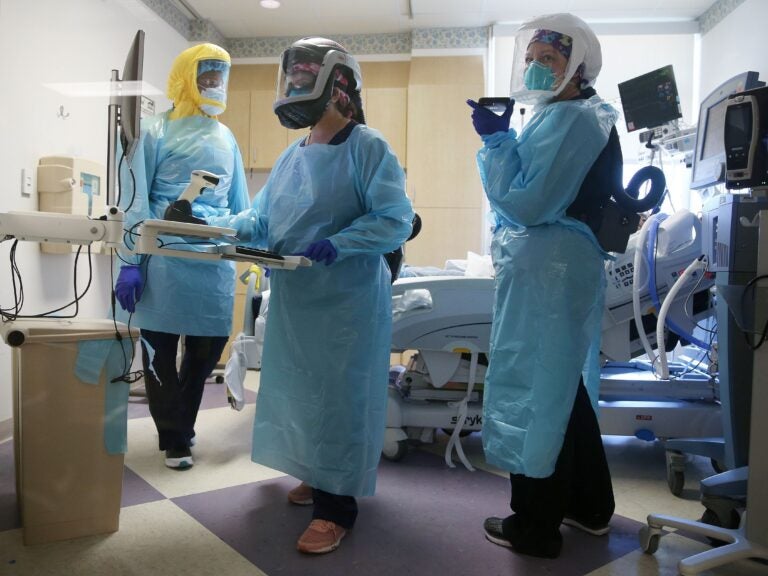 COVID-19 mortality rates are going down, according to studies of two large hospital systems, partly thanks to improvements in treatment. Here, clinicians care for a patient in July at an El Centro, Calif., hospital. Clinicians care for a COVID-19 patient in the Intensive Care Unit
