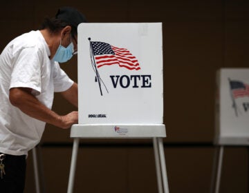 A voter fills out his ballot during early voting