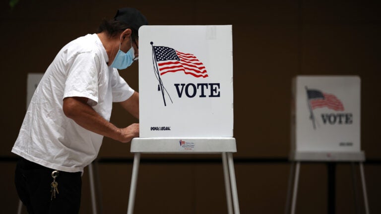 A voter fills out his ballot during early voting