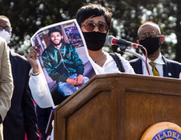 Tamika Morales holds a photo of her son Ahmad, who was killed July 2020 in South Philadelphia. (Kimberly Paynter/WHYY)