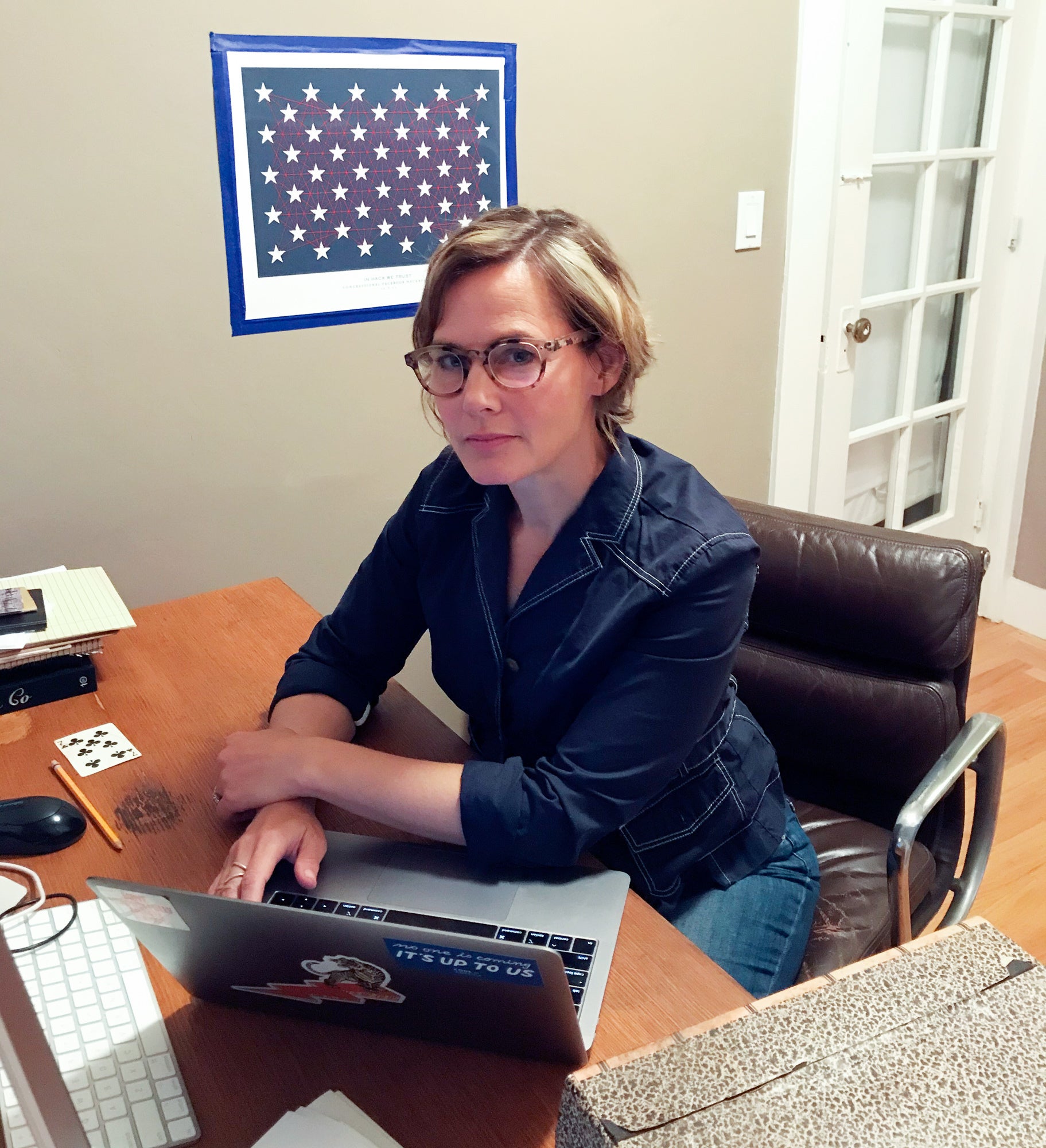 Jennifer Pahlka sits at a desk