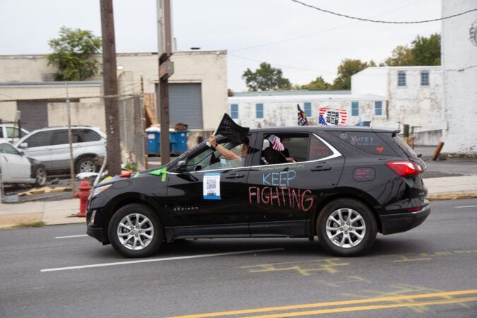 Stephanie Vincent drives her car in a protest parade