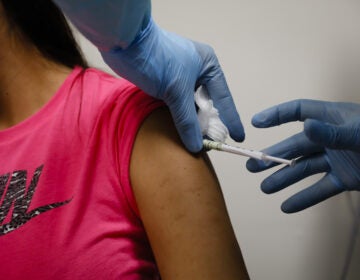A volunteer receives an injection during COVID-19 vaccine trial