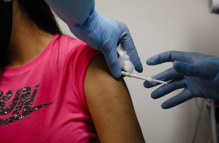 A volunteer received an injection as part of a clinical trial for a COVID-19 vaccine at Research Centers of America in Hollywood, Fla. Studies of vaccines backed by Operation Warp Speed have enrolled tens of thousands of people in a matter of months. A volunteer receives an injection during COVID-19 vaccine trial