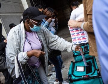 Jean Gary drops off her ballot at City Hall