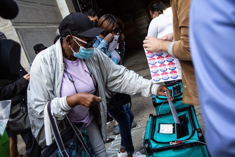 Jean Gary drops off her ballot at City Hall