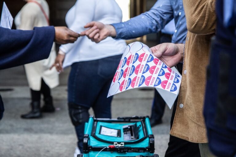 Voters receive a sticker after voting at one of Philadelphia’s satellite election offices