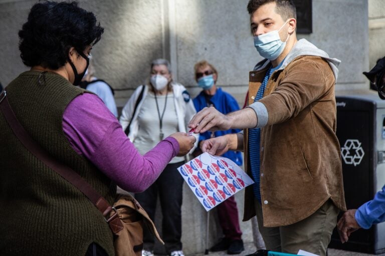 Voters receive a sticker after voting at one of Philadelphia’s satellite election offices