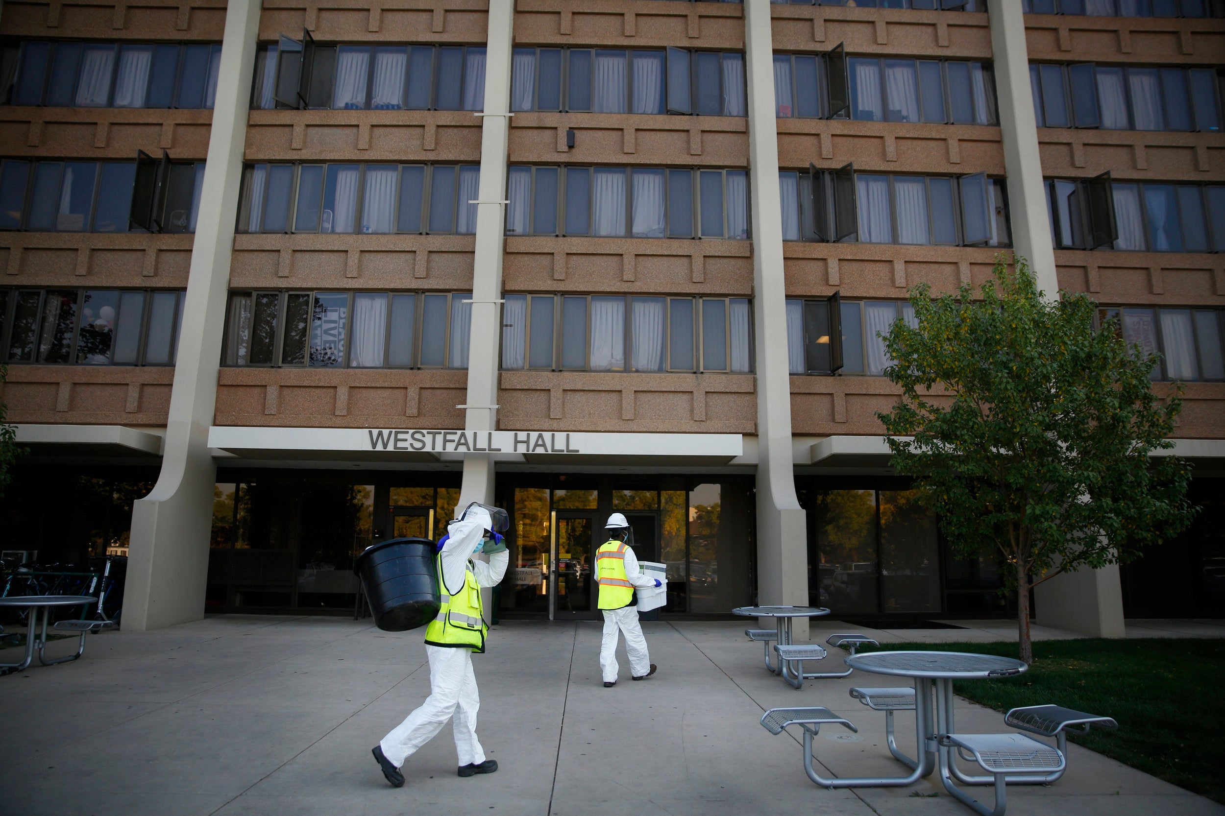 Researchers carry buckets outside Westfall Hall