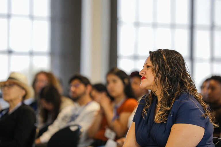 Karla Monterroso says after going to Alameda Hospital in May with a very accelerated heart rate, very low blood pressure and cycling oxygen levels, her entire experience was one of being punished for being ‘insubordinate.’ Karla Monterroso sits in the foreground of a room of people