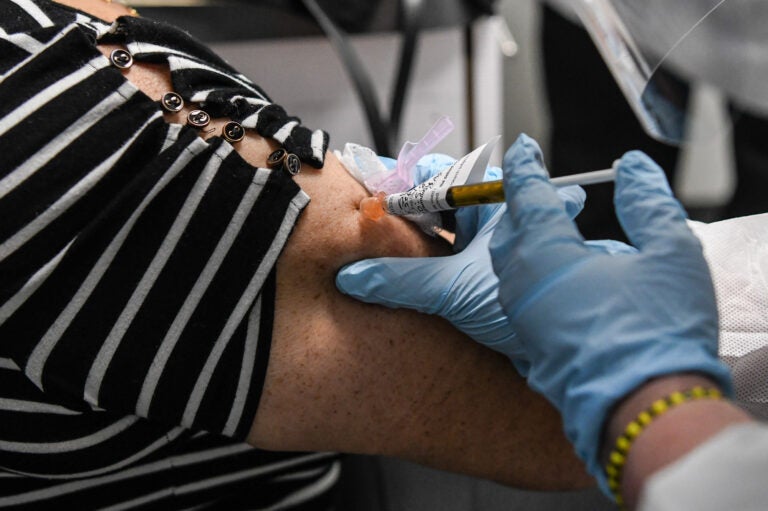 Sandra Rodriguez, 63, receives a COVID-19 vaccination from Yaquelin De La Cruz at the Research Centers of America (RCA) in Hollywood, Florida, on Aug. 13, 2020. (Photo by Chandan Khanna/AFP via Getty Images) 