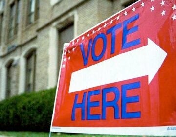 A sign points voters in the direction of a polling place