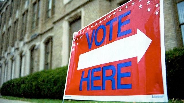 A sign points voters in the direction of a polling place