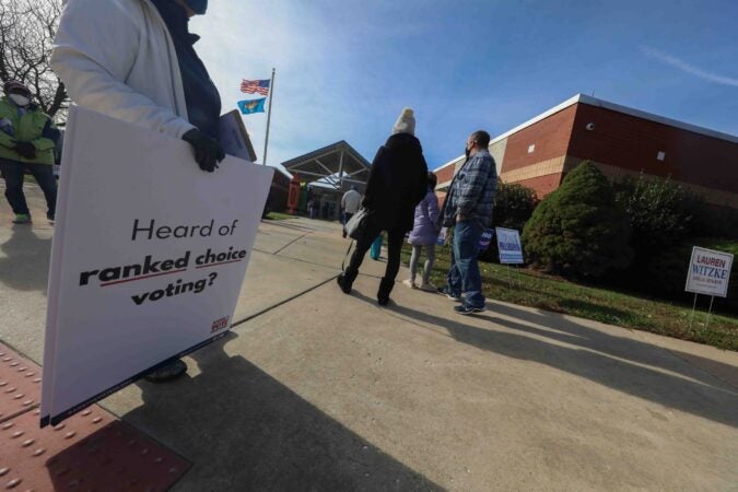 Voters wait in a long line in the cold to cast their vote on election day Tuesday, November 3, 2020, at Thurgood Marshall Elementary School in Newark, Del. (Saquan Stimpson for WHYY)