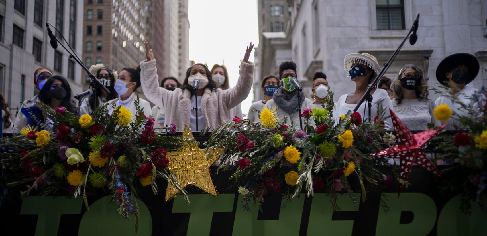 The Resistance Revival Chorus performs in front of City Hall, onboard a flatbed truck, as part of a voter motivational effort called 