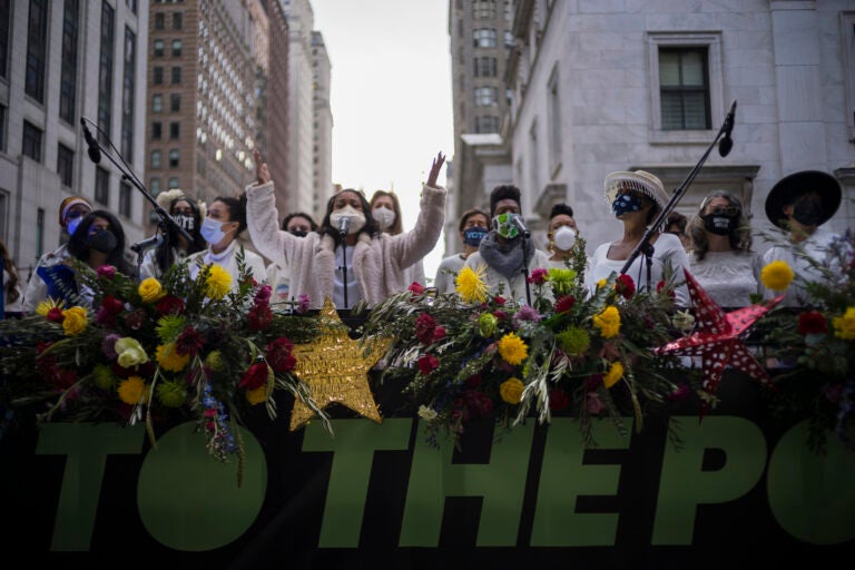 The Resistance Revival Chorus performs in front of City Hall, onboard a flatbed truck, as part of a voter motivational effort called 