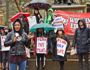 Gina Dukes, a Penn alumna and a Philadelphia school district teacher, speaks at a rally to demand UPenn make PILOT payments. (Kimberly Paynter/WHYY)