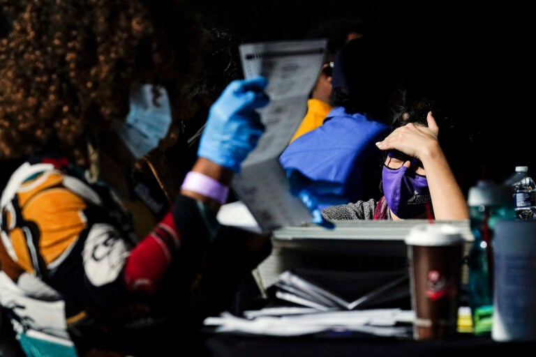 A election supervisor answer questions for the election workers as they count ballots at State Farm Arena on Thursday, Nov. 5, 2020, in Atlanta. (AP Photo/Brynn Anderson)