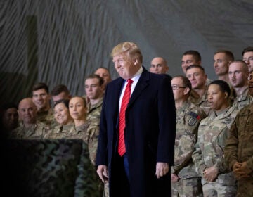 FILE - In this Nov. 28, 2019, file photo President Donald Trump smiles before addressing members of the military during a surprise Thanksgiving Day visit at Bagram Air Field, Afghanistan. (AP Photo/Alex Brandon, File)