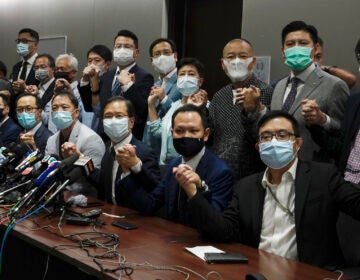 Hong Kong's pro-democracy legislators pose a picture before a press conference at Legislative Council in Hong Kong, Wednesday, Nov. 11, 2020.  Hong Kong’s pro-democracy lawmakers announced that they are resigning en masse following a move by the city’s government to disqualify four pro-democracy legislators. (AP Photo/Vincent Yu)