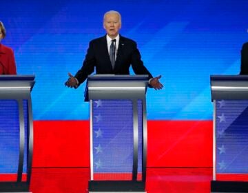 In this Feb. 7, 2020, file photo Democratic presidential candidate former Vice President Joe Biden, center, speaks as Sen. Elizabeth Warren, D-Mass., left, and Sen. Bernie Sanders, I-Vt., listen during a Democratic presidential primary debate hosted by ABC News, Apple News, and WMUR-TV at Saint Anselm College in Manchester, N.H. (AP Photo/Elise Amendola)