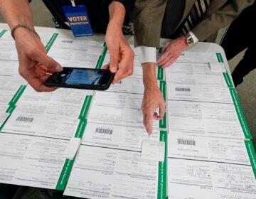 a canvas observer photographs Lehigh County provisional ballots as vote counting in the general election continues in Allentown, Pa.