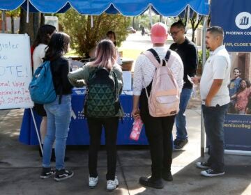 In this Sept. 24, 2019 file photo students at Phoenix College gather to fill out voter registration forms on National Voter Registration Day on campus, in Phoenix. (AP Photo/Ross D. Franklin)