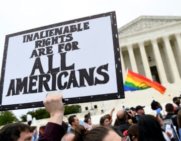 In this Oct. 8, 2019, file photo, protesters gather outside the Supreme Court in Washington where the Supreme Court is hearing arguments in the first case of LGBT rights since the retirement of Supreme Court Justice Anthony Kennedy.  (AP Photo/Susan Walsh)