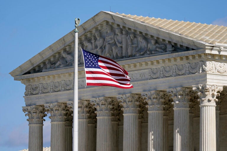 An American flag waves in front of the Supreme Court building