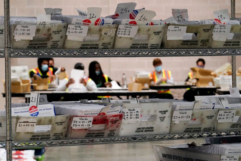 Workers with the Philadelphia City Commissioners office sort election materials