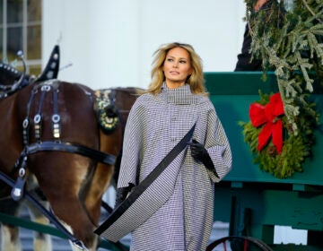 First lady Melania Trump stands next to the 2020 Official White House Christmas tree
