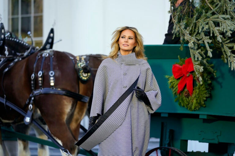 First lady Melania Trump stands next to the 2020 Official White House Christmas tree