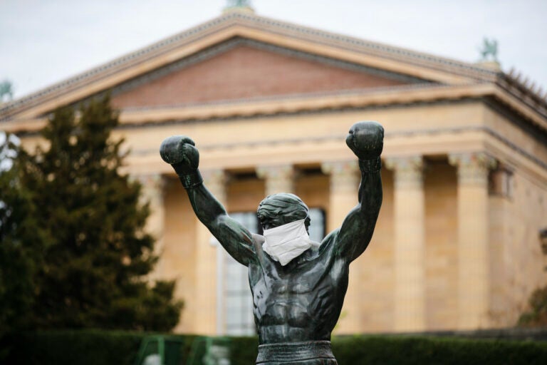 The Rocky statue is outfitted with a mock surgical face mask