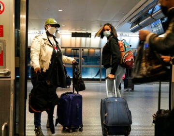 Travelers leave the AirTrain at JKF International Airport