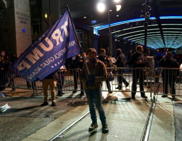 A Trump supporter stands outside the Pennsylvania Convention Center