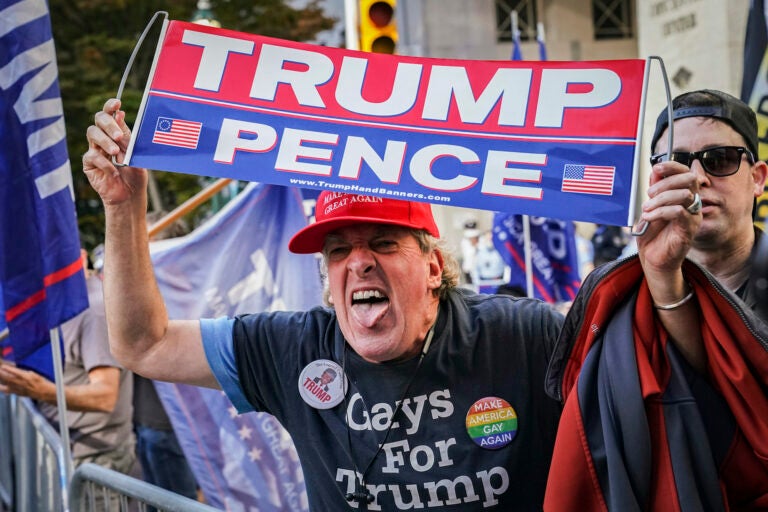 An angry supporter of President Donald Trump shouts at crowds of celebrating demonstrators after the 2020 presidential election is called for President-elect Joe Biden, Saturday, Nov. 7, 2020, in Philadelphia.