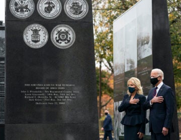 President-elect Joe Biden, and Jill Biden, stand with their hands over their hearts before placing a wreath at the Philadelphia Korean War Memorial