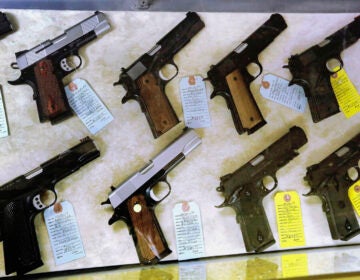In this July 10, 2013 file photo, semi-automatic handguns are seen displayed for purchase at an arms supply store in Springfield, Ill. (AP Photo/Seth Perlman)