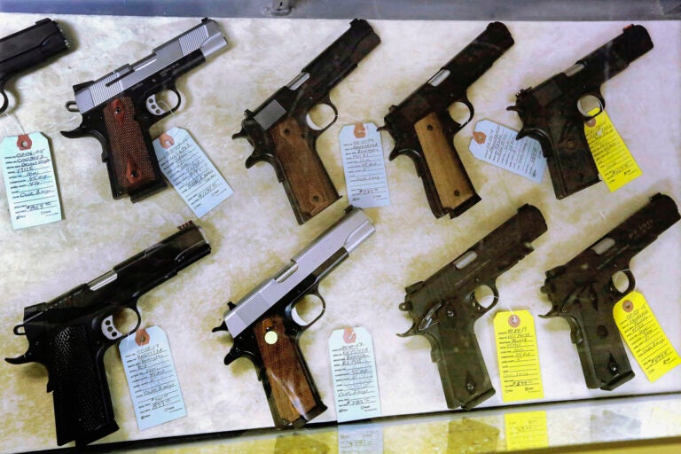 In this July 10, 2013 file photo, semi-automatic handguns are seen displayed for purchase at an arms supply store in Springfield, Ill. (AP Photo/Seth Perlman)