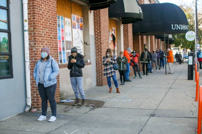 Voters practice social distance while lining up at polling place in Northern Liberties in Philadelphia on Election Day. (Miguel Martinez for WHYY)