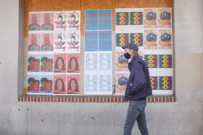 A Philadelphia voter waits in line to cast his vote in person on Election Day. (Miguel Martinez for WHYY)