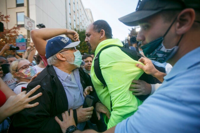 A Trump supporter clashes with Biden supporters during celebrations outside the Philadelphia Convention Center