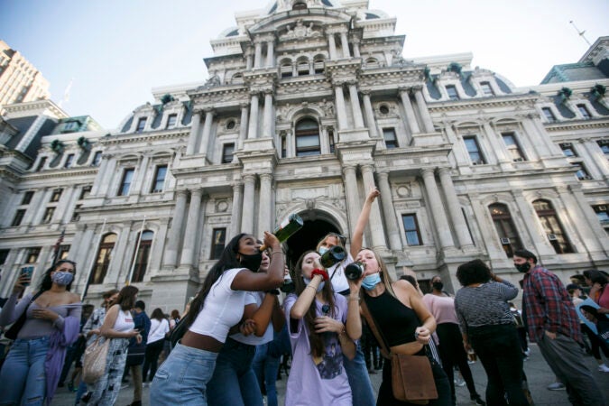 Joe Biden supporters drink in celebration of Biden's projected win