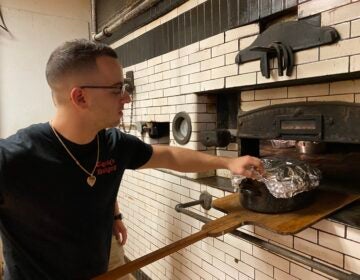 Baker Joe Cacia roasts Thanksgiving turkeys for customers at Cacia's Bakery in South Philly. (Liz Tung / WHYY)