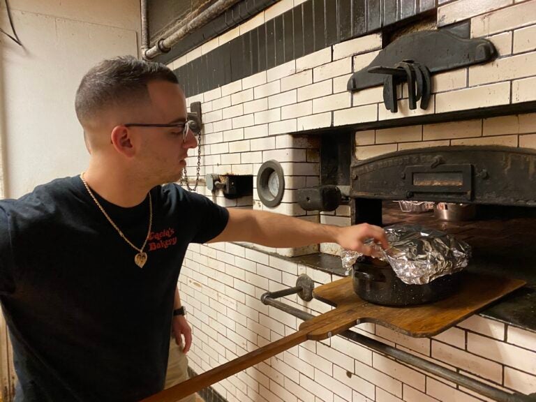 Baker Joe Cacia roasts Thanksgiving turkeys for customers at Cacia's Bakery in South Philly. (Liz Tung / WHYY)